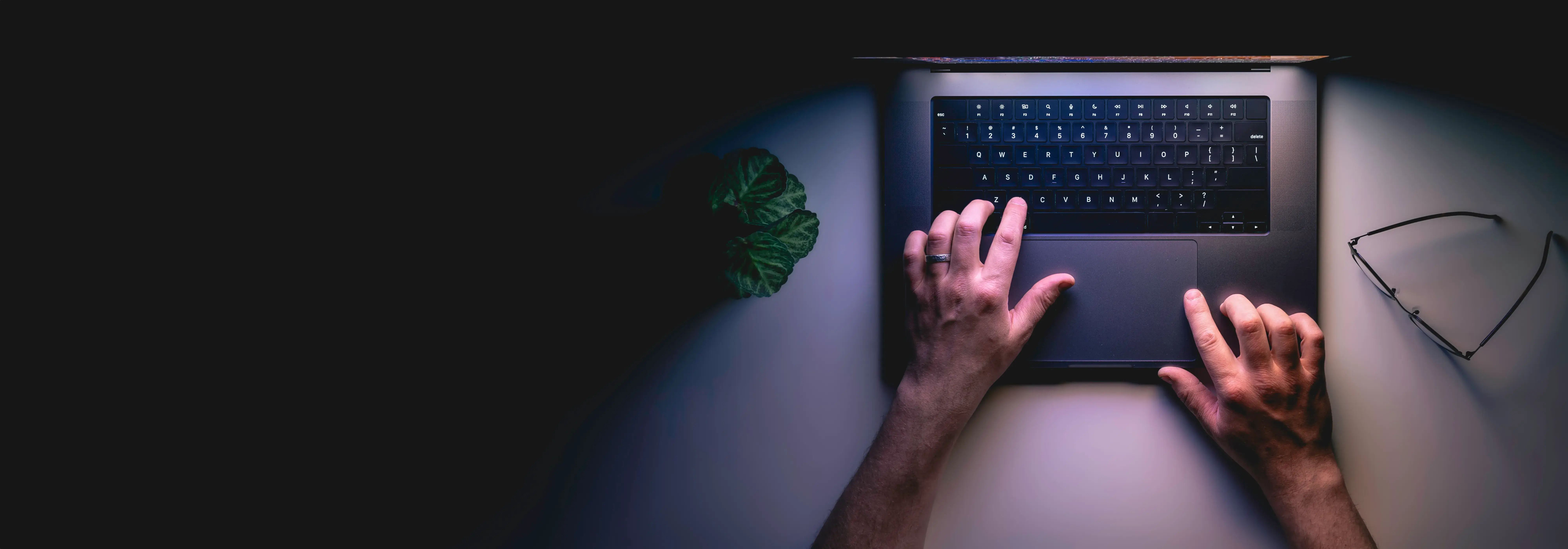Software developer working on a laptop in an office